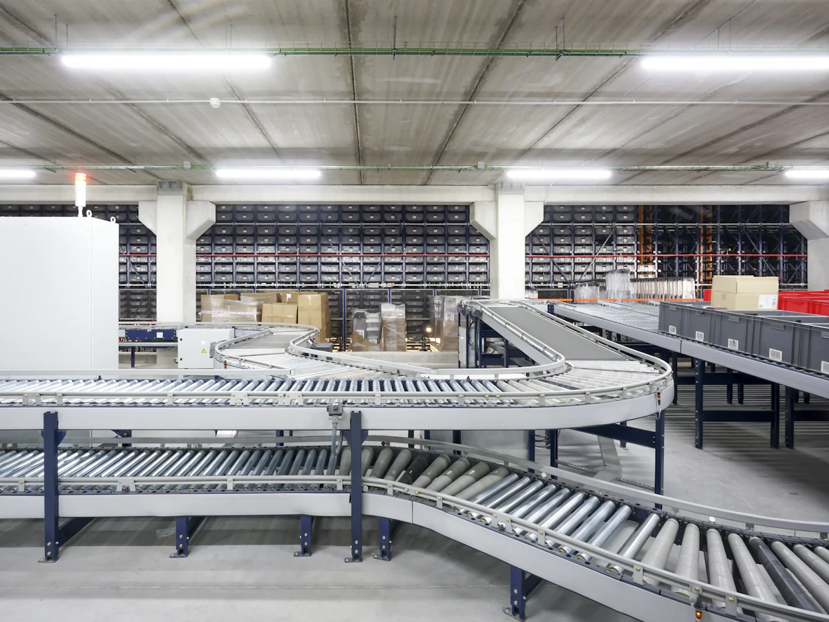 Conveyor line in a large warehouse — CCTV and AcuSense NVR supply for logistics